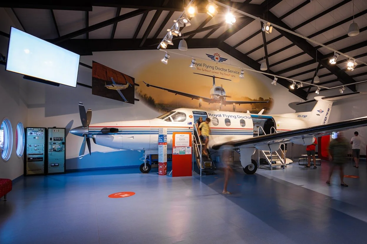 A genuine RFDS Pilatus PC-12 inside the museum, visitors climbing aboard