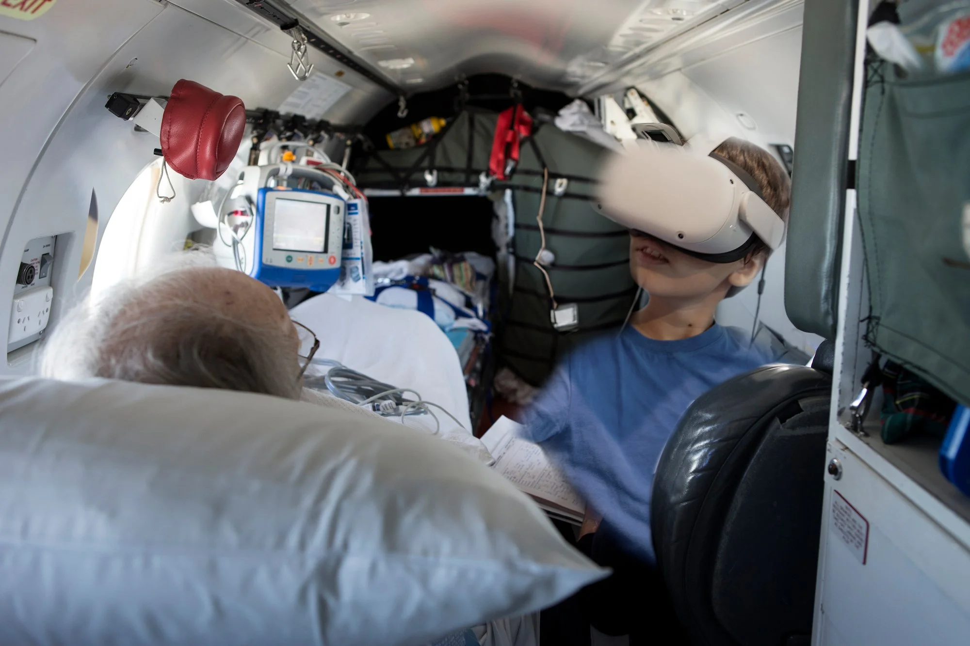 A young visitor wearing a VR headset inside the PC-12 medical cabin